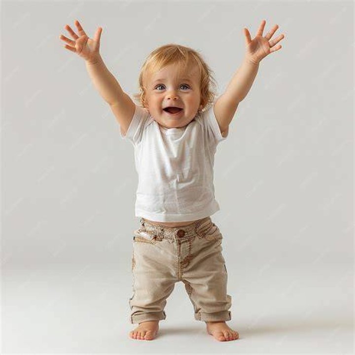 Child Standing In A Baby Cage